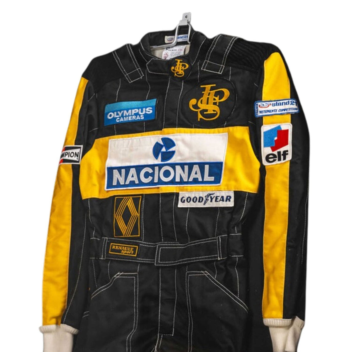 Ayrton Senna Racing Suit Replica 1985 with multiple brand logos.