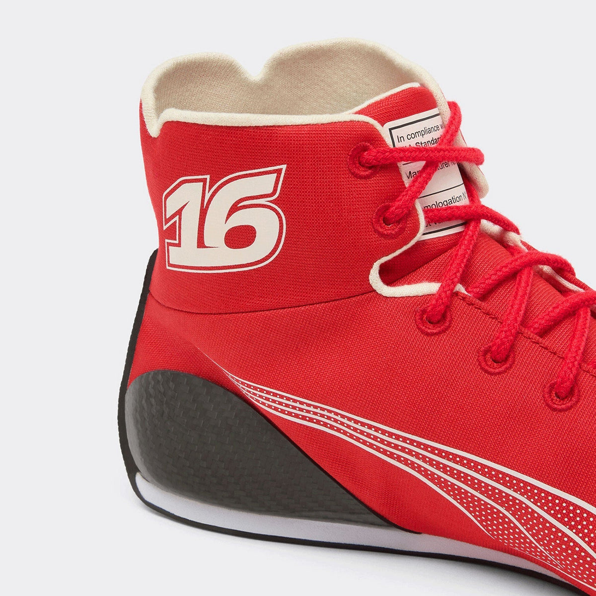 2026 Charles Leclerc Racing Shoes Replica: close-up of a red high-top sneaker with white '16' branding on the ankle, red laces, a black and white sole, and a light beige inner lining.