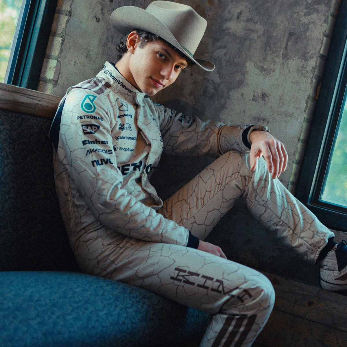 2025 Racing Suit Replica – Andrea Kimi Antonelli Usa Austin GP: andrea Kimi Antonelli 2025 F1 Race Suit Replica Mercedes USA Austin GP with sponsor logos sitting on a couch.