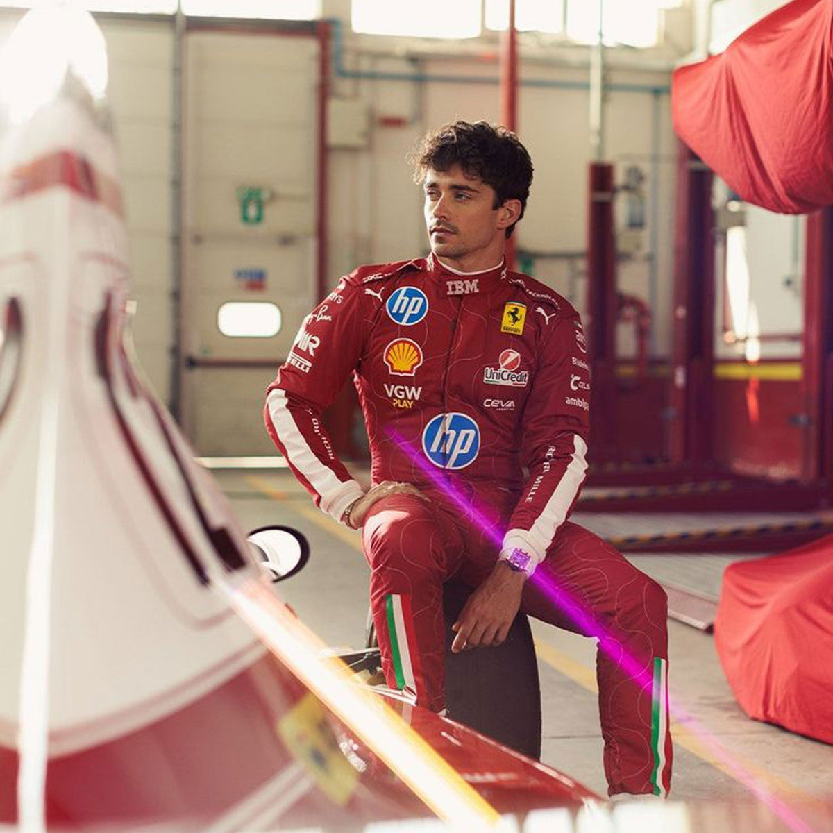 2025 Racing Suit Replica – Charles Leclerc Monza GP: charles Leclerc 2025 F1 Race Costume Ferrari Monza GP with multiple sponsor logos in a garage setting.