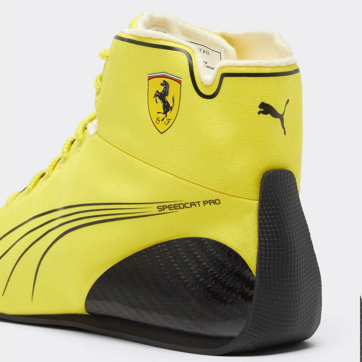 2026 Lewis Hamilton British GP Racing Shoes Replica: a close-up of a Puma Speedcat Pro high-top sneaker in bright yellow with black accents, featuring the Scuderia Ferrari shield logo on the side and a black Puma cat logo on the heel.