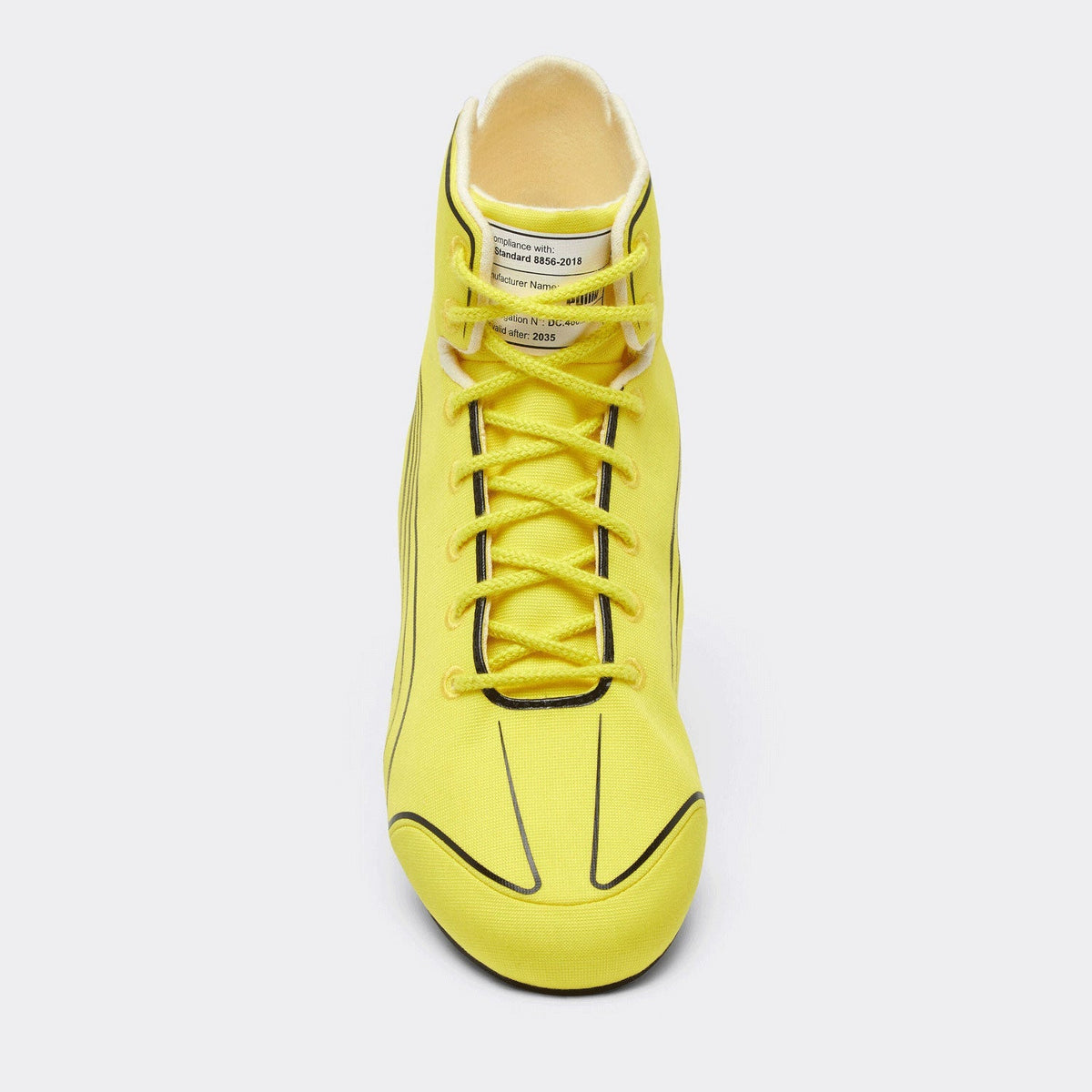2026 Lewis Hamilton British GP Racing Shoes Replica: a close-up of a Puma Speedcat Pro high-top sneaker in bright yellow with black accents, featuring the Scuderia Ferrari shield logo on the side and a black Puma cat logo on the heel.