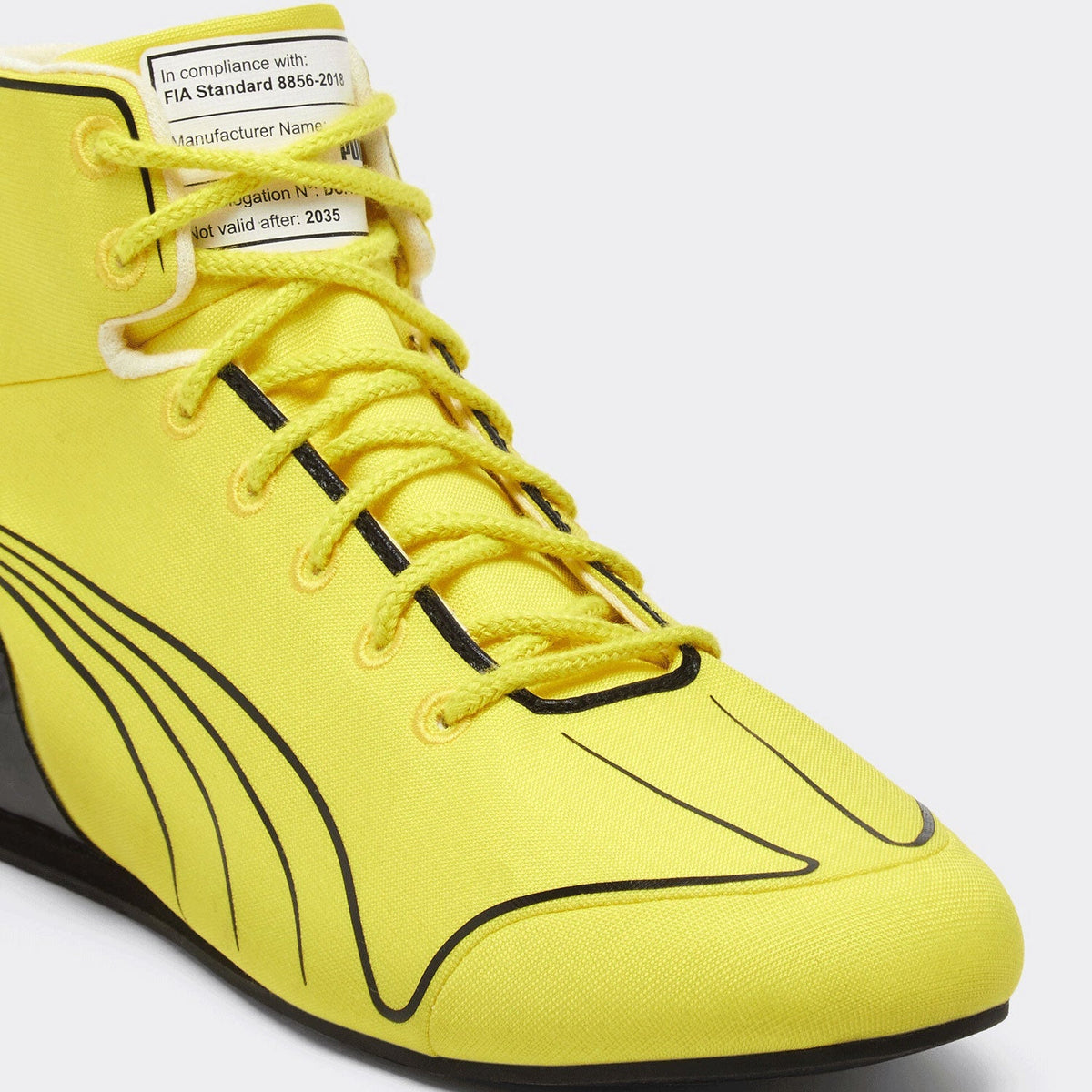 2026 Lewis Hamilton British GP Racing Shoes Replica: a close-up of a bright yellow high-top sneaker with black graphic lines and yellow laces.
