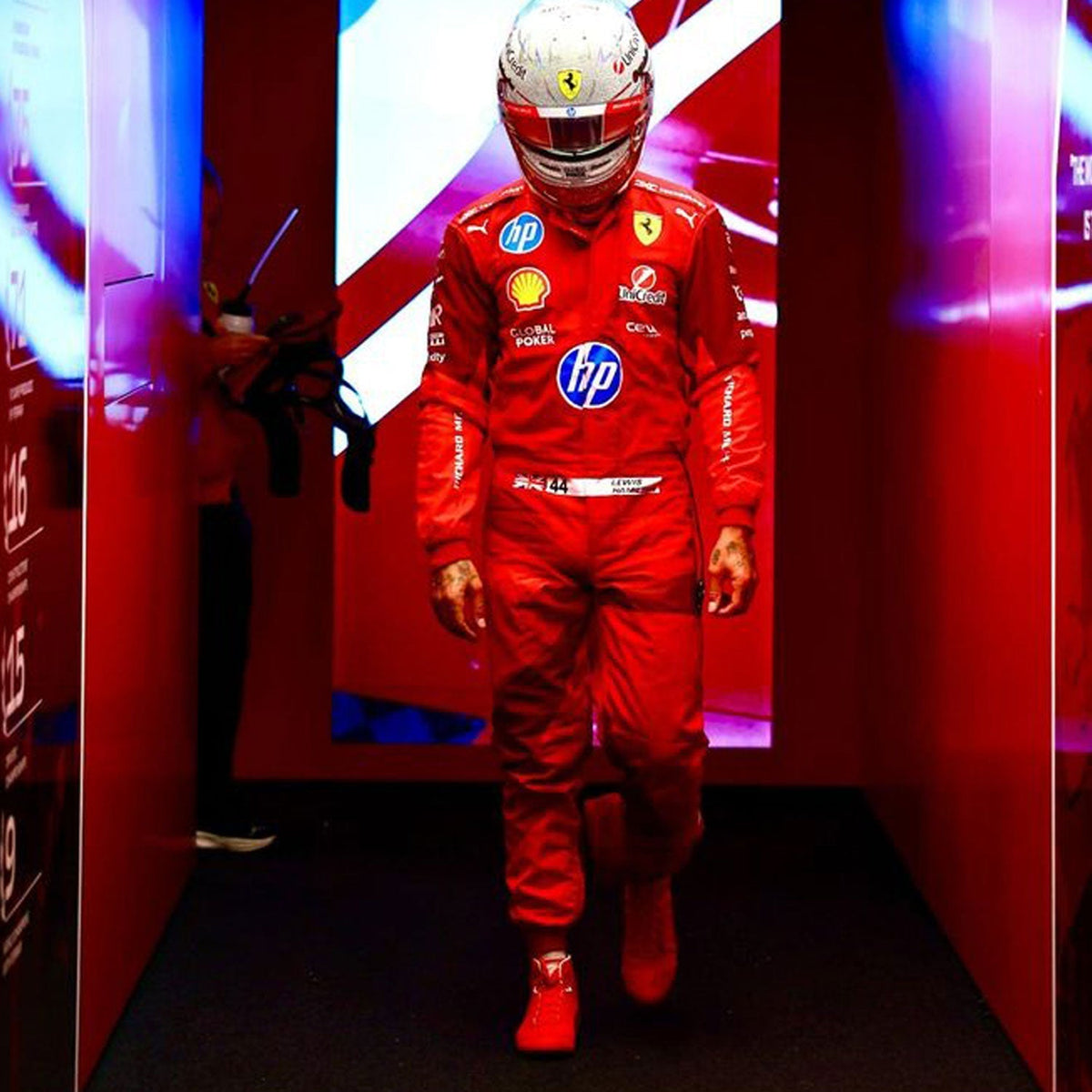 2025 Lewis Hamilton Las Vegas GP Racing Suit Replica: lewis Hamilton 2025 F1 Race Suit Ferrari Las Vegas GP with various sponsor logos in a red-themed room.